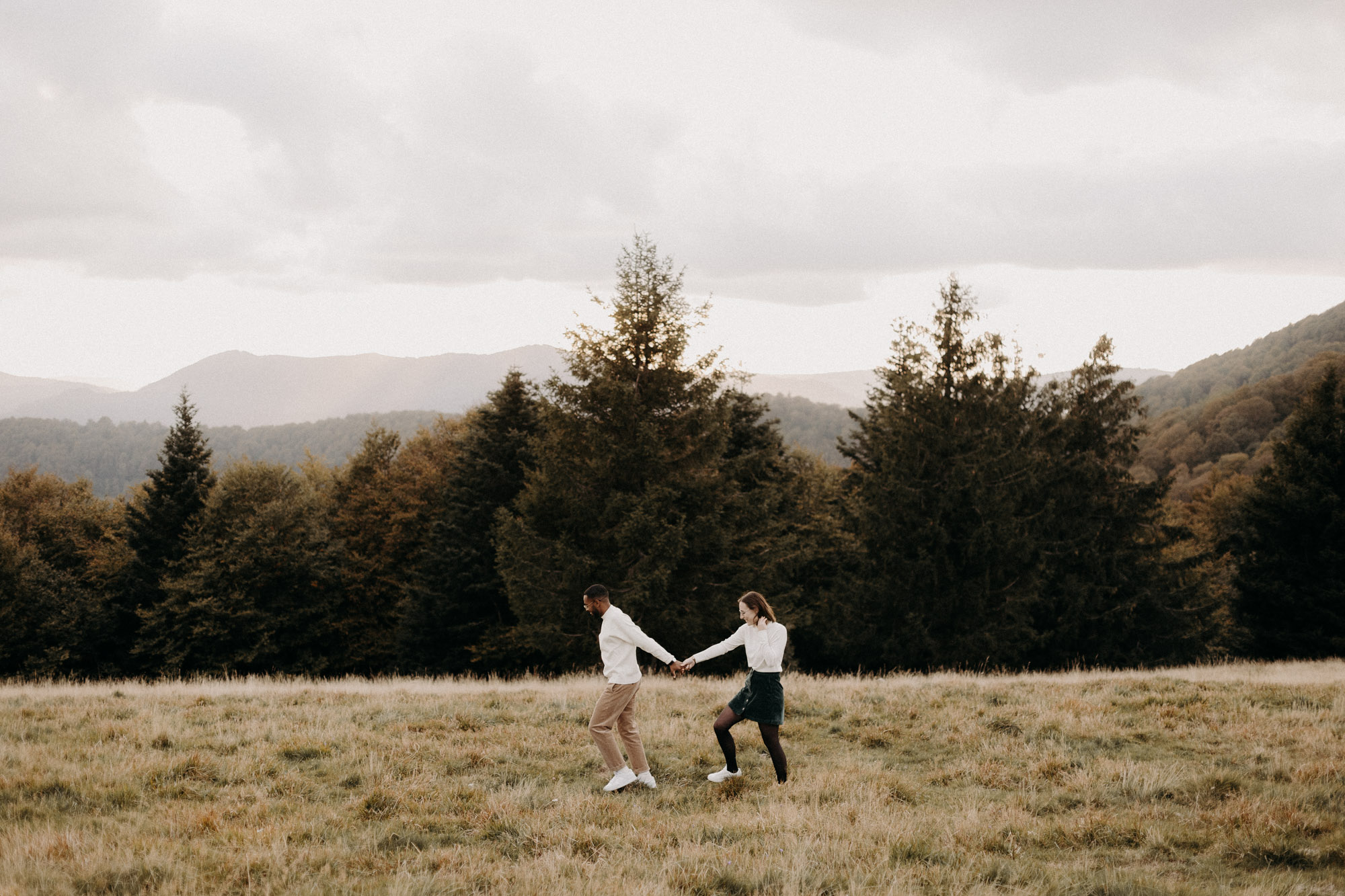 deux amoureux marchent main dans la main en montagne